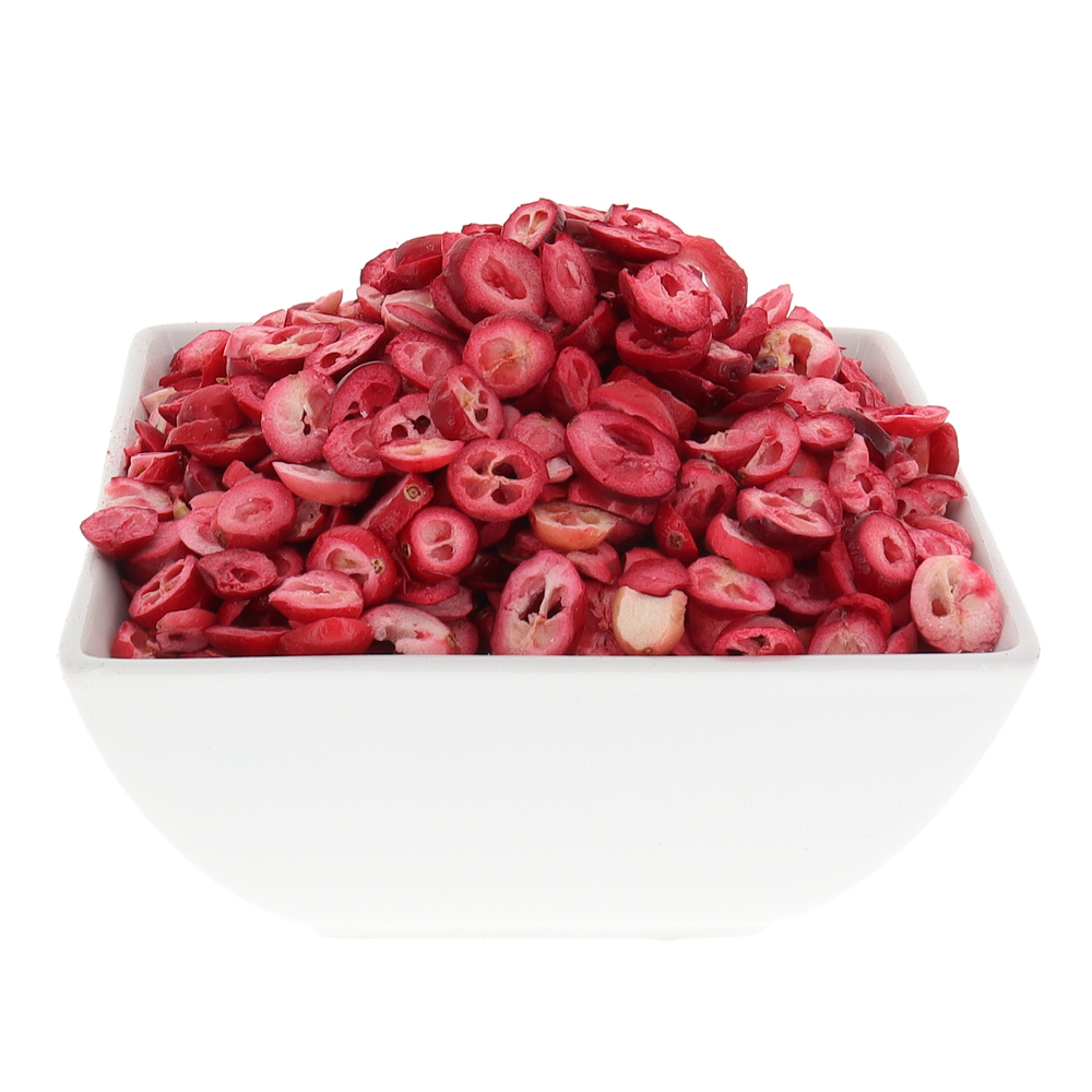 White bowl filled with dried pink cranberries on a white background